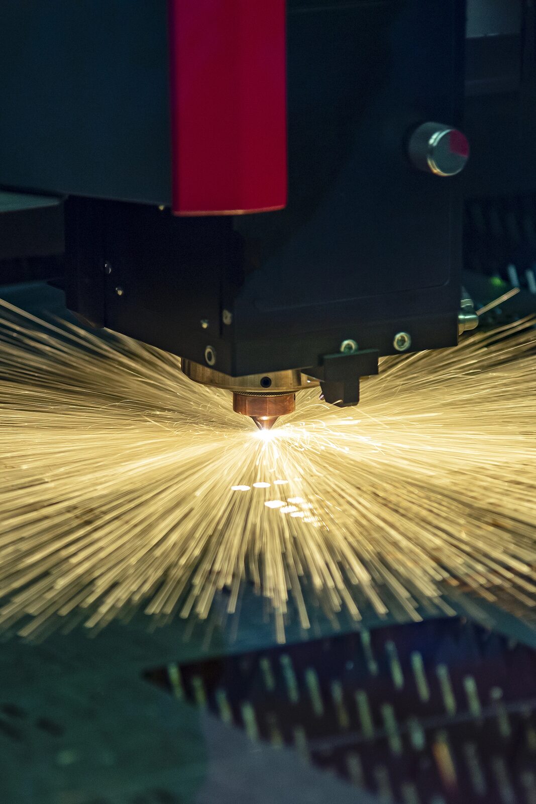 Machine operator monitoring a laser cutter
